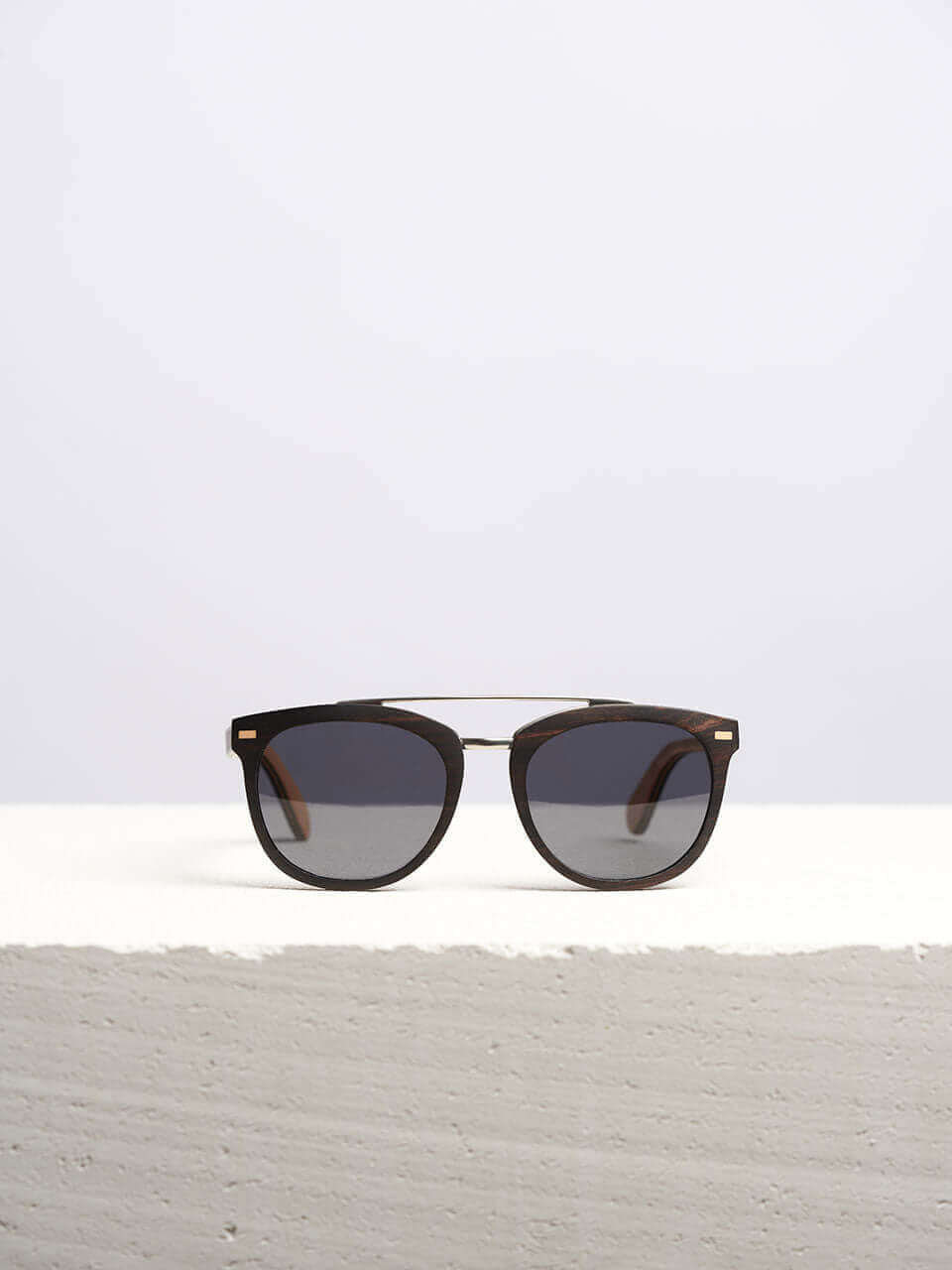 sunglasses kept on a white platform