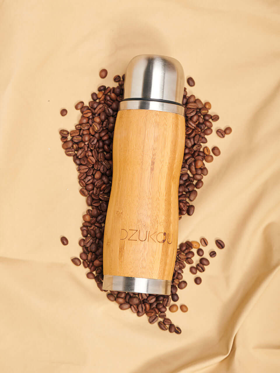 bottle lying on a sheet of coffee beans