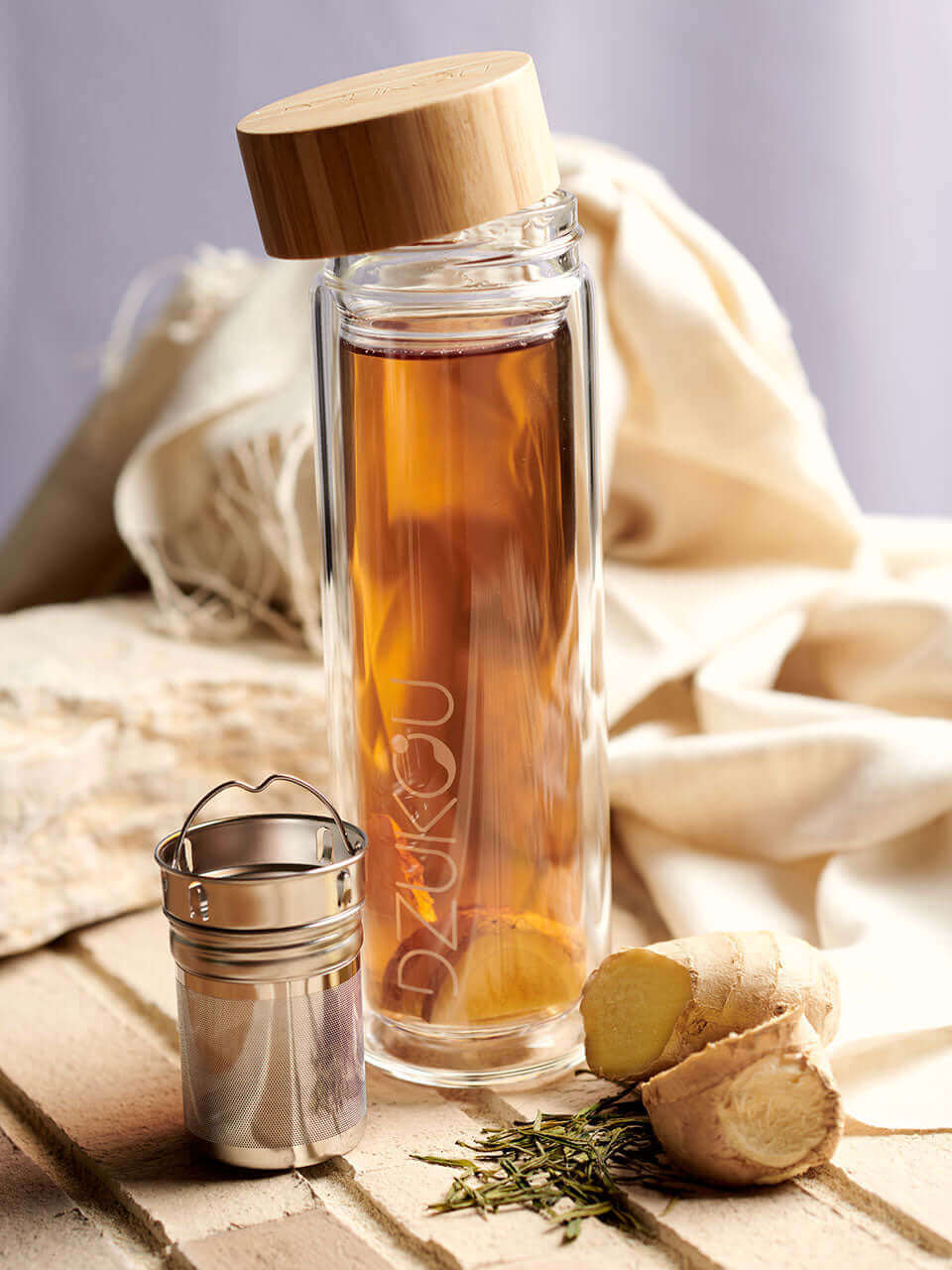 Glass bottle with infuser containing tea